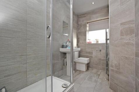 A pristine, modern bathroom featuring elegant l...