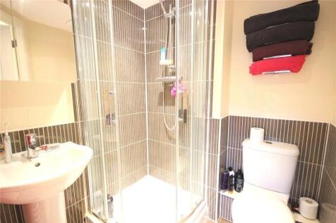 Bright and modern bathroom suite featuring a sp...