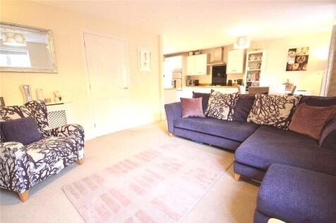 Comfortable living room featuring a spacious L-...