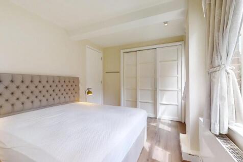 Bright and spacious master bedroom featuring a ...