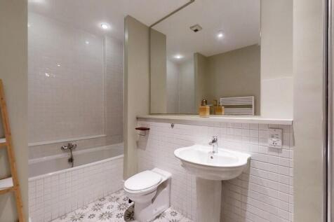 A modern and spacious bathroom suite featuring ...