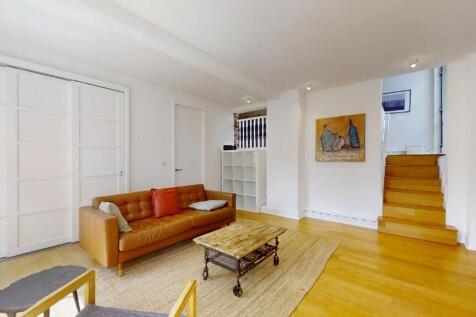 A bright and inviting living room featuring con...
