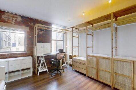 A cozy single bedroom featuring a bright window...