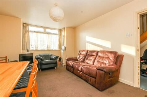 A cozy living room featuring a large brown leat...