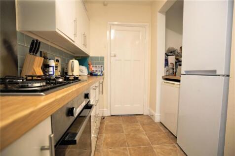 A neat and modern kitchen featuring a wooden co...