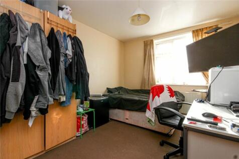 A cozy single bedroom featuring a comfortable b...