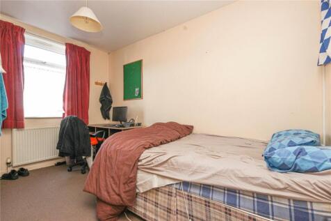 Cozy single bedroom featuring a comfortable bed...