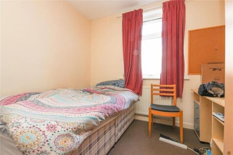 A cozy single bedroom featuring a comfortable b...