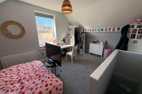 A bright and cozy double bedroom featuring two ...