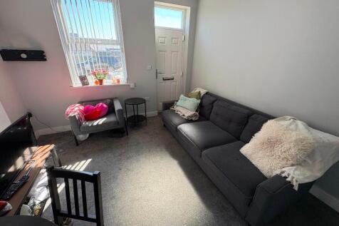 Bright and cozy living room featuring a comfort...