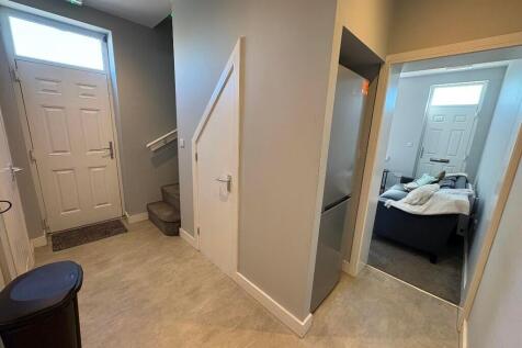 A clean and well-lit hallway featuring a front ...
