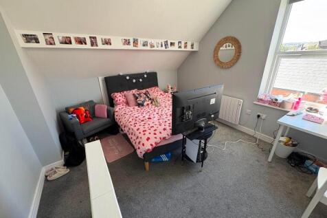 Cozy single bedroom with a comfortable bed, a d...