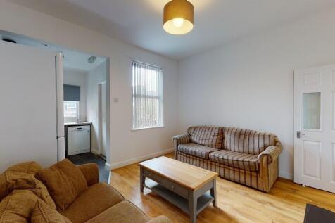A bright and welcoming living room featuring co...