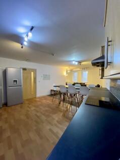 A modern kitchen featuring a large dining table...