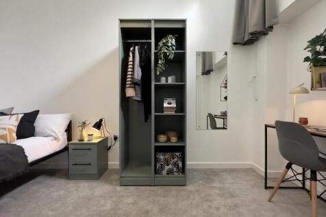 A stylish double bedroom featuring a well-organ...