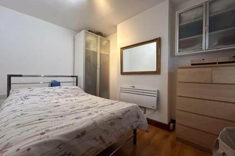 Cozy double bedroom featuring a comfortable bed...