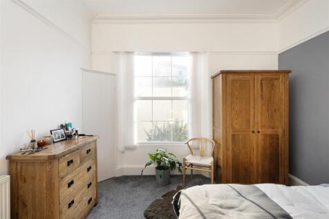 A bright and inviting double bedroom featuring ...