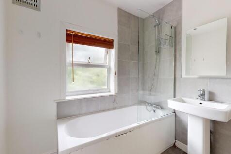 A bright and modern bathroom featuring a white ...