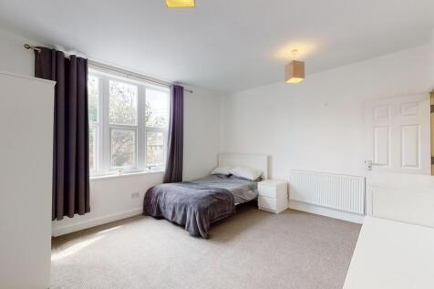 Bright and neatly arranged double bedroom featu...