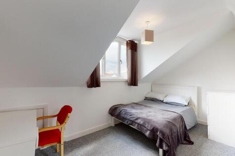 A bright and cozy double bedroom featuring a co...