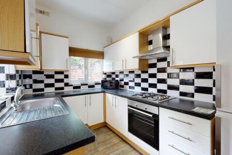Bright and modern kitchen featuring a sleek bla...
