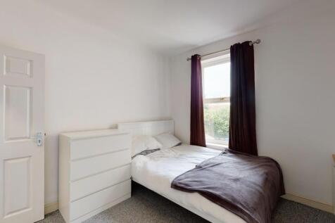 Bright and tidy single bedroom featuring a cozy...