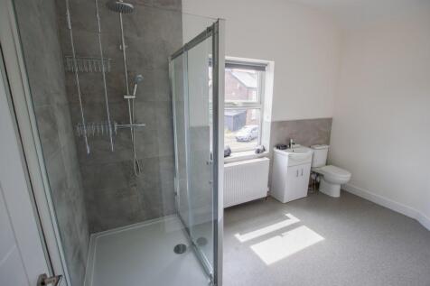 Bright and modern bathroom suite featuring a sp...