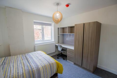 A bright and neatly arranged double bedroom fea...