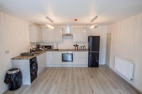 Bright and modern kitchen featuring light wood ...
