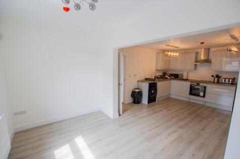 Bright and modern kitchen with sleek white cabi...