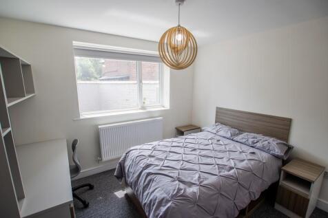 A cozy double bedroom featuring a comfortable d...