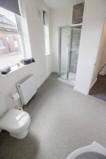 Bright and clean bathroom featuring a roomy sho...