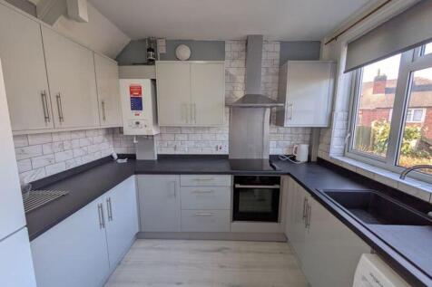 A modern and spacious kitchen featuring ample s...