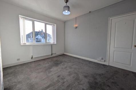 A spacious and bright living room with ample na...