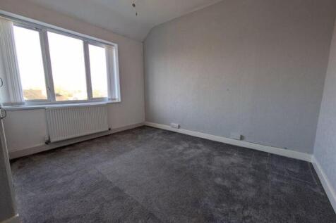A spacious and bright double bedroom featuring ...