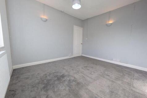 A spacious and inviting living room with modern...