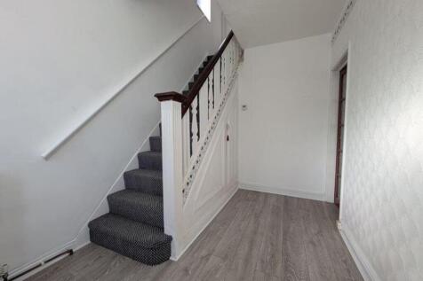 A clean and bright hallway with stylish decor, ...