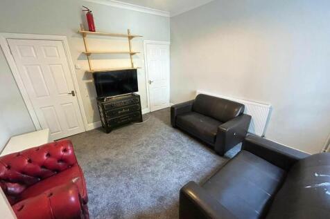 A cozy living room featuring comfortable sofas ...