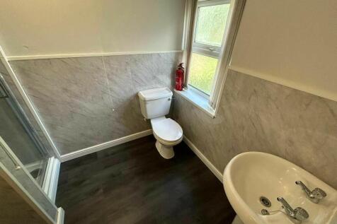 Bright bathroom featuring a modern white sink, ...
