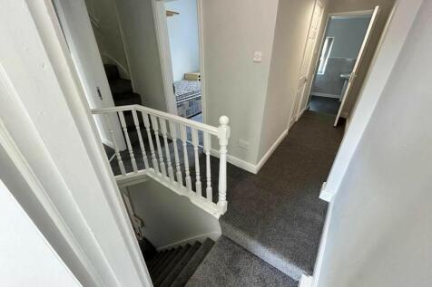 A clean and well-maintained hallway with neutra...