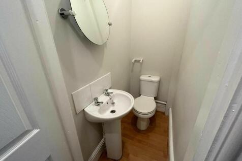 A clean and compact single toilet room featurin...