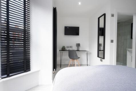 This stylish double bedroom features modern dec...