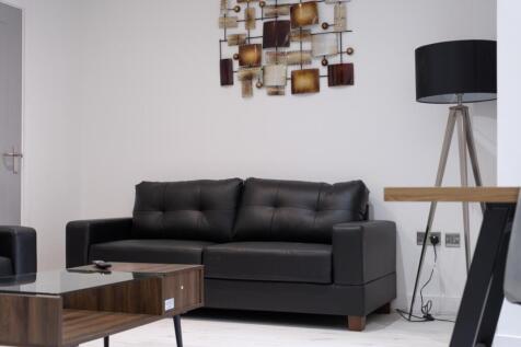 A stylish living room featuring a comfortable b...