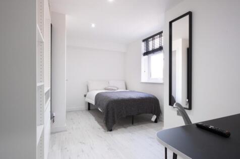 A stylish double bedroom featuring a comfortabl...