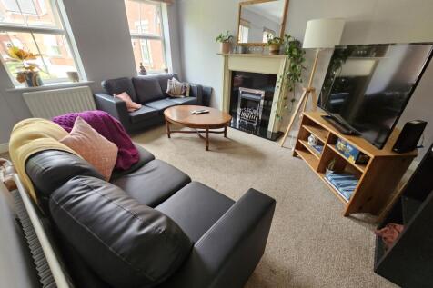 A bright and inviting living room featuring com...