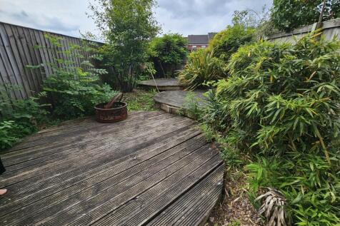 A charming garden space featuring tiered wooden...
