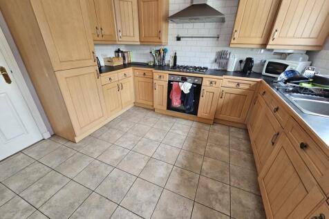 A bright and spacious kitchen featuring ample w...