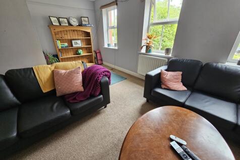 A bright and cozy living room featuring comfort...