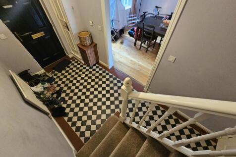A bright and tidy staircase featuring neutral c...