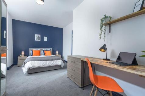A modern and spacious master bedroom featuring ...